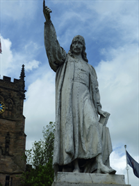 Statue of Baxter in Kidderminster with St. Mary's Church in the background